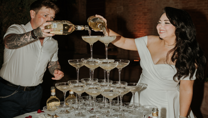 italian-wedding-couple-pouring-champagne-tower